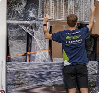 Mover wrapping furniture in protective plastic