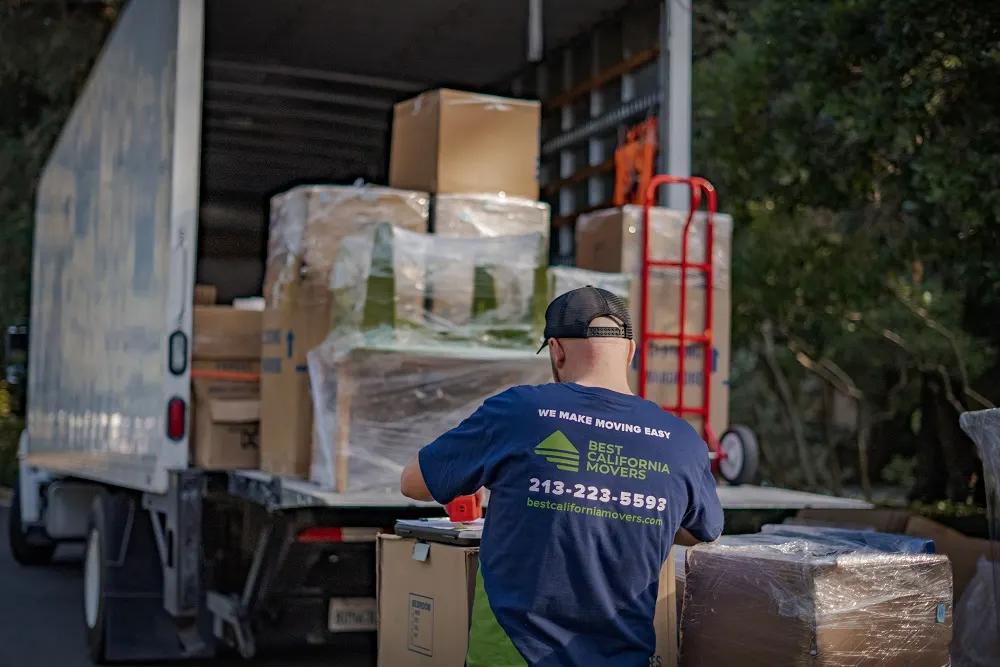 Best California Movers mover loading wrapped boxes and furniture into a moving truck